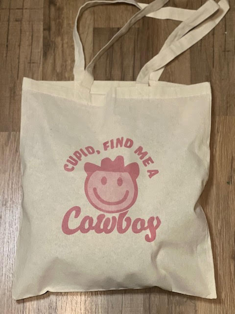 cupid, find me  a cowboy tote bag